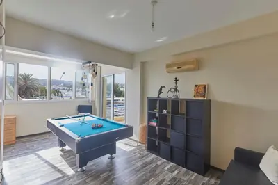 a living room with a pool table in it at Spectacular Sea View, private jacuzzi & table pool in Protaras