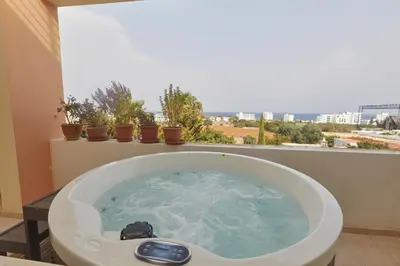 a bath tub in a bathroom with a view at Spectacular Sea View, private jacuzzi & table pool in Protaras