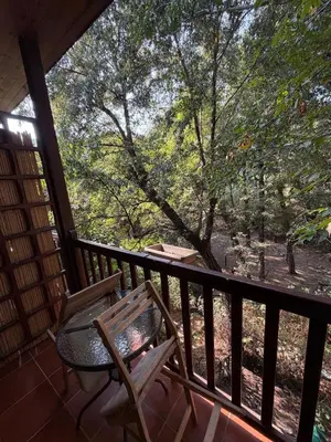 a balcony with a table and a chair on a porch at GaliniCafe22-suites in Kakopetria