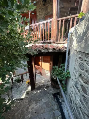 a stairway leading to a house with a wooden deck at GaliniCafe22-suites in Kakopetria