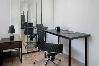 an office with a black desk and two chairs at Urban Condo 43 - 1 Bdr in Nicosia