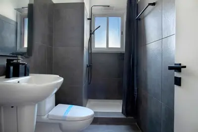 a bathroom with a sink and a toilet and a shower at Urban Condo 43 - 1 Bdr in Nicosia