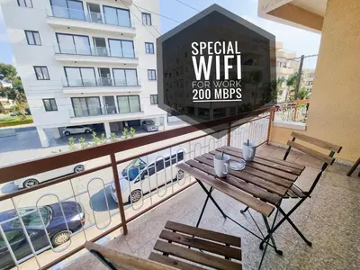 a balcony with a bench and a sign that reads special wifi for work m at Luxury City Rooms - Smart TV with Netflix in Larnaka