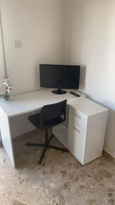 a white desk with a computer monitor and a chair at Luxury City Rooms - Smart TV with Netflix in Larnaka