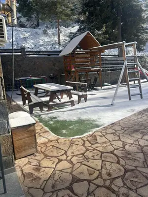 a playground with a picnic table and a swing at DIAMOND Stone Wooden Guest House in Khandria