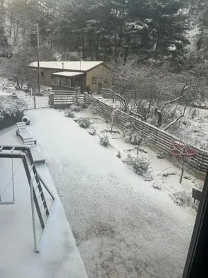 a snow covered yard in front of a house at DIAMOND Stone Wooden Guest House in Khandria