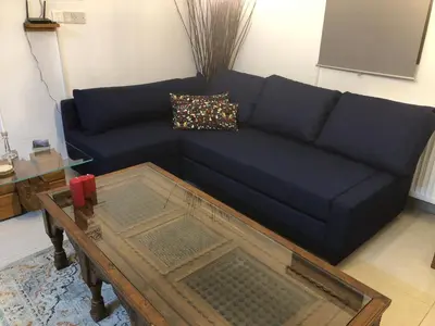 a living room with a blue couch and a coffee table at DIAMOND Stone Wooden Guest House in Khandria
