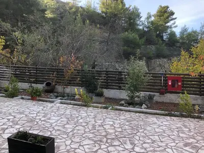 a garden with a fence and some plants at DIAMOND Stone Wooden Guest House in Khandria
