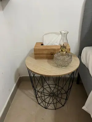 a glass vase on a table next to a bed at HESTIA Studio Downtown Nicosia in Nicosia