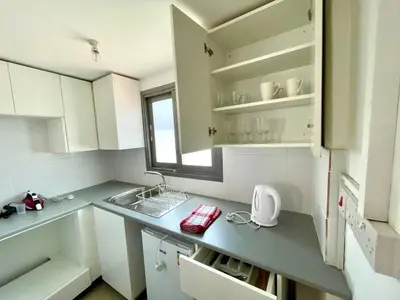 a kitchen with a counter with a sink and a window at Nemesis Second floor studio in downtown Nicosia in Nicosia