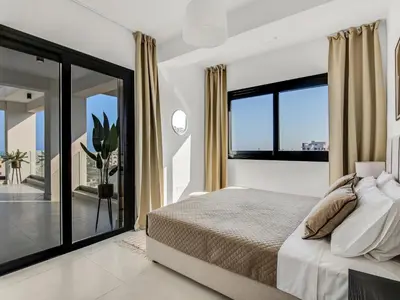 a bedroom with a bed and a large window at Sanders Elgio in Limassol