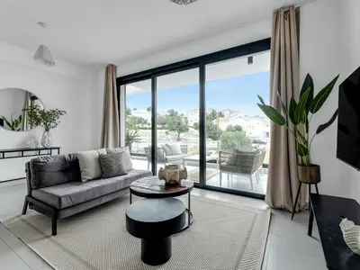 a living room with a couch and a table at Sanders Elgio in Limassol