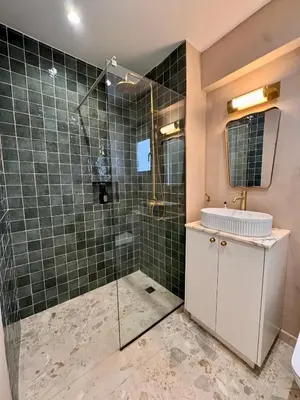 a bathroom with a shower with a sink and a mirror at Liberty House - Central Two Bedroom Apartments in Nicosia