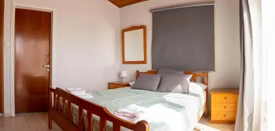 a bedroom with a large bed in a room at Spyros No23 Charming Oceanview Maisonette in Meneou