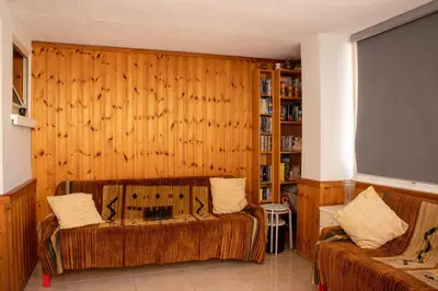 a living room with wooden walls and a couch at Spyros No23 Charming Oceanview Maisonette in Meneou