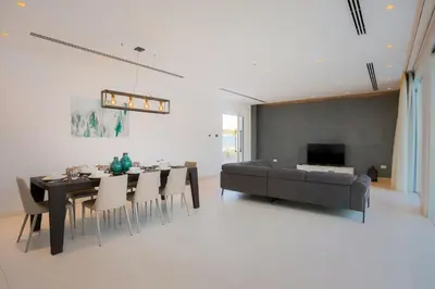a living room with a dining table and a couch at Cove Seaview Villas - Neptune in Ayia Napa
