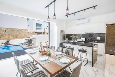 a kitchen and dining room with a table and chairs at Vie Bleu 1 in Protaras