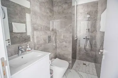 a bathroom with a shower and a toilet and a sink at Vie Bleu 1 in Protaras