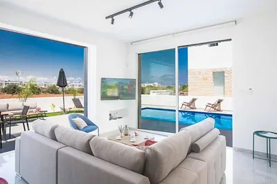 a living room with a couch and a pool at Vie Bleu 3 in Protaras