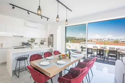 a kitchen and dining room with a table and chairs at Vie Bleu 3 in Protaras