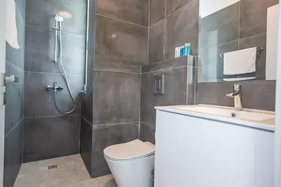 a bathroom with a shower and a toilet and a sink at Vie Bleu 3 in Protaras