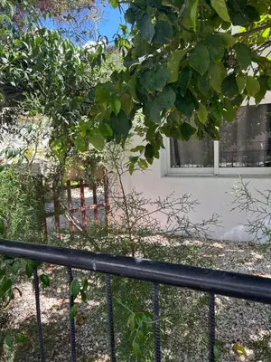 a black fence in front of a building with a window at Avra House in Limassol