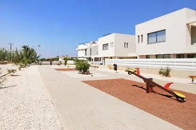 a park with a bench in front of a building at Queen Lydia in Protaras