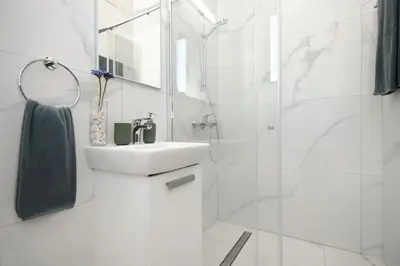 a white bathroom with a sink and a shower at Queen Lydia in Protaras