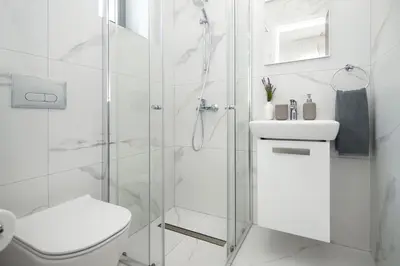 a bathroom with a shower and a toilet and a sink at Queen Lydia in Protaras