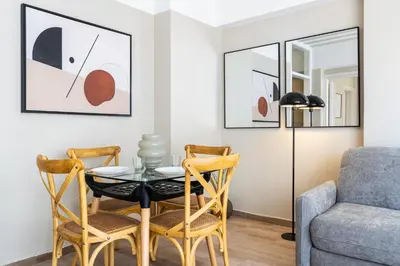 a living room with a table and chairs and a couch at Berries 1-BR Apt in Larnaca in Larnaka