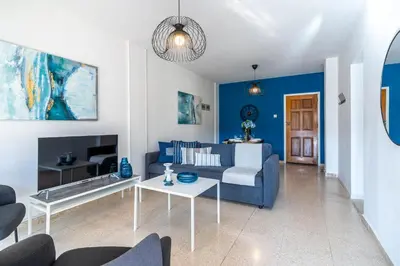 a living room with a couch and a table at Azure 2-BR W/Terrace in Larnaca in Larnaka