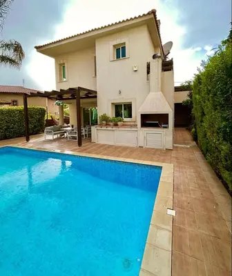 a house with a swimming pool in front of a house at El Soleo Luxury Villa in Limassol