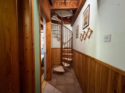 a hallway with a staircase in a house at Kapilio Cottage House in Kapilio