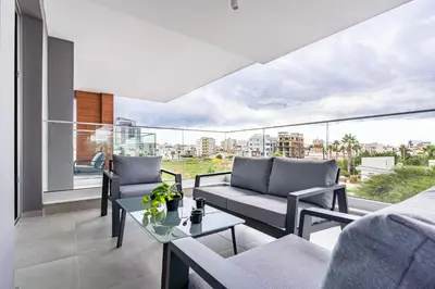 a living room with two couches and a table at Sunshine 1-Bedroom Apartment in Larnaca in Larnaka