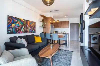 a living room with a couch and a table at Sunshine 1-Bedroom Apartment in Larnaca in Larnaka