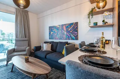a living room with a couch and a table at Sunshine 1-Bedroom Apartment in Larnaca in Larnaka
