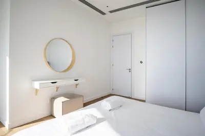 a white bedroom with a mirror and a bed at 360 Nicosia-3 bedrooms Panoramic Deluxe Residence in Nicosia