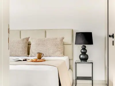 a bedroom with a bed with a table and a lamp at Sanders Only in Limassol