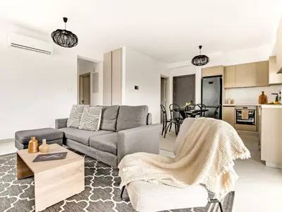 a living room with a couch and a table at Sanders Only in Limassol