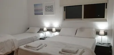 a white bedroom with two beds and two lamps at LINA'S HOME & POOL - Breakbooking CY in Laxia
