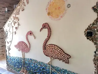 three flamingos on the wall of a room at Mosaic villa by the sea in Protaras