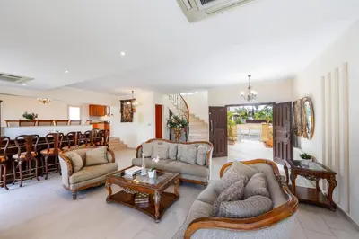a living room with couches and a bar at Protaras Posidon By The Sea in Protaras