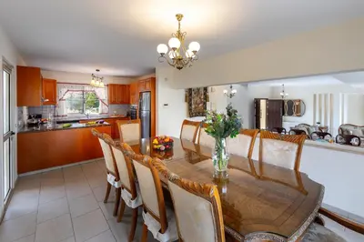 a kitchen and dining room with a table and chairs at Protaras Posidon By The Sea in Protaras