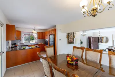 a kitchen and dining room with a table and chairs at Protaras Posidon By The Sea in Protaras