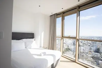 a bedroom with a white bed and large windows at 360 Nicosia-3 bedrooms Exclusive Panoramic View Residence in Nicosia