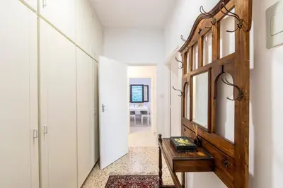 a hallway with a wooden door and a table at Platres Forty Pine Trees Cottage in Platres