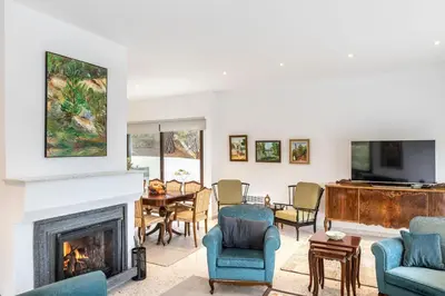 a living room with a fireplace and a tv at Platres Forty Pine Trees Cottage in Platres
