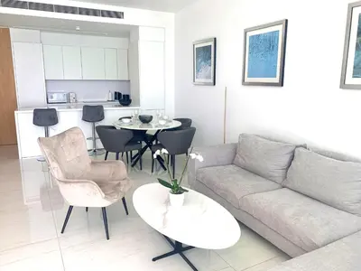 a living room with a couch and a table at Del Mar Beachfront Boutique Residence in Limassol