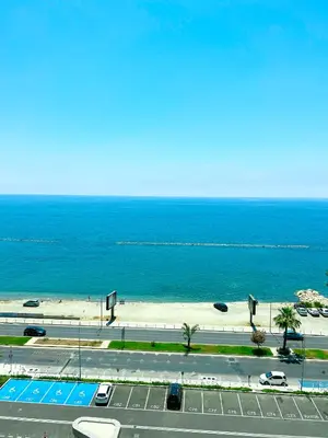 a view of a road and a beach with the ocean at Del Mar Beachfront Boutique Residence in Limassol