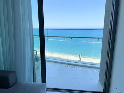 a view of the beach from a room with a window at Del Mar Beachfront Boutique Residence in Limassol